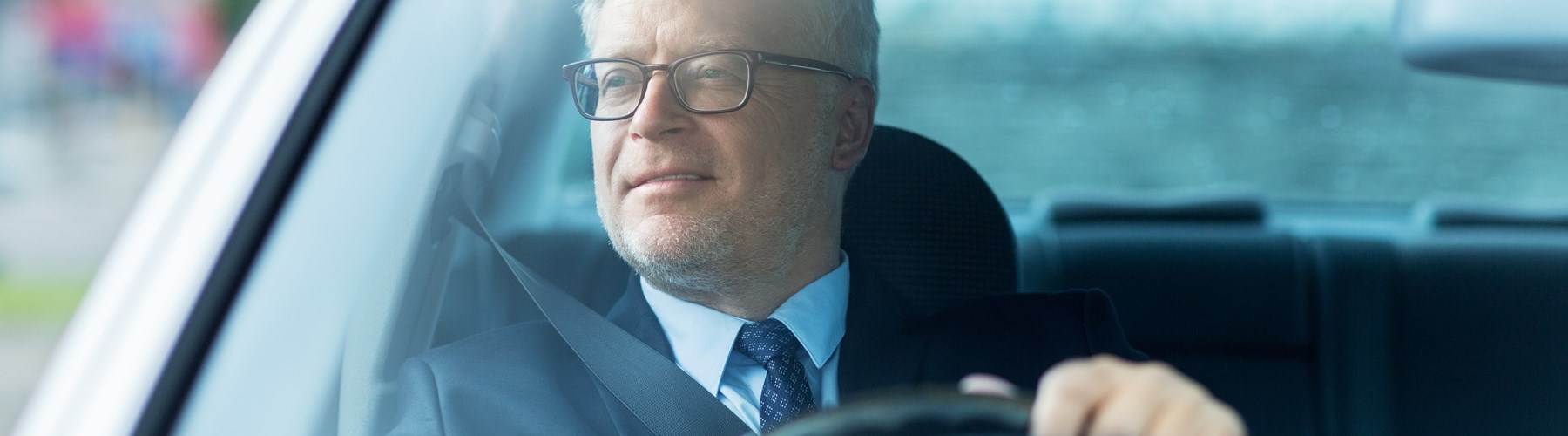 Older man driving car