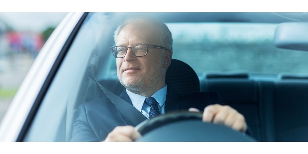 Older man driving car