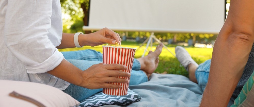 Couple getting ready to watch film outdoors