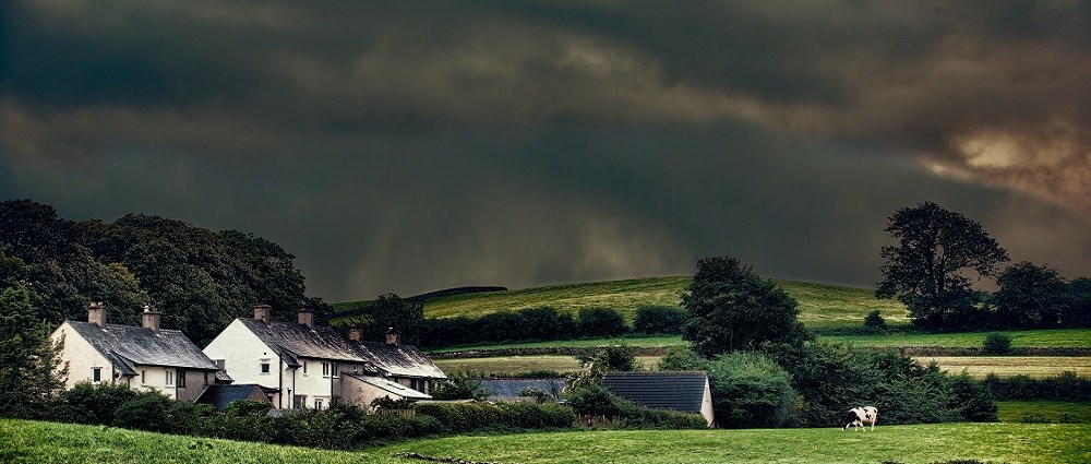 A stormy sky above houses in the countryside