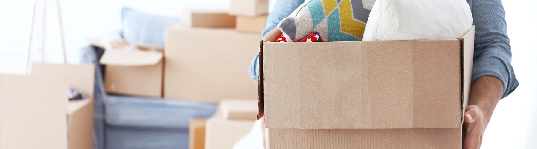 A woman holding a box with belongings inside