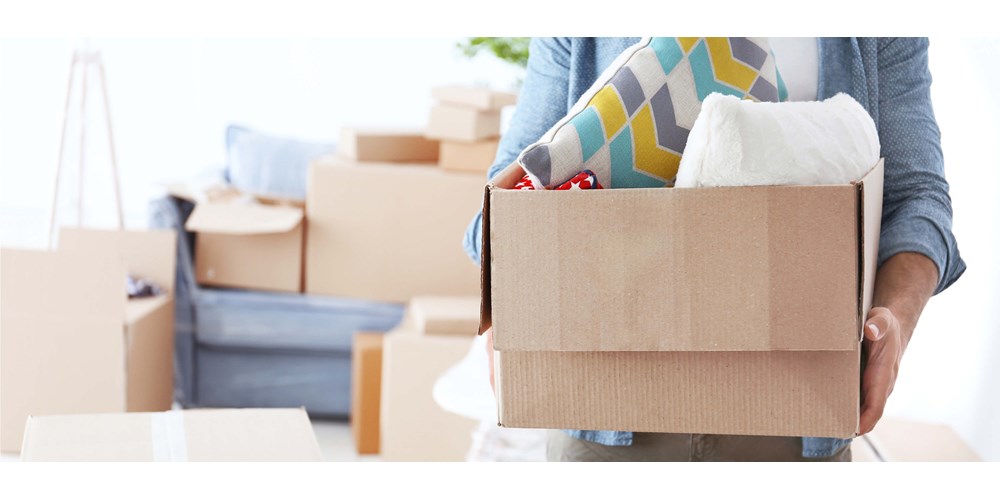 A woman holding a box with belongings inside