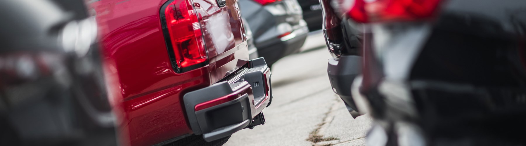 Line of used cars at a dealership