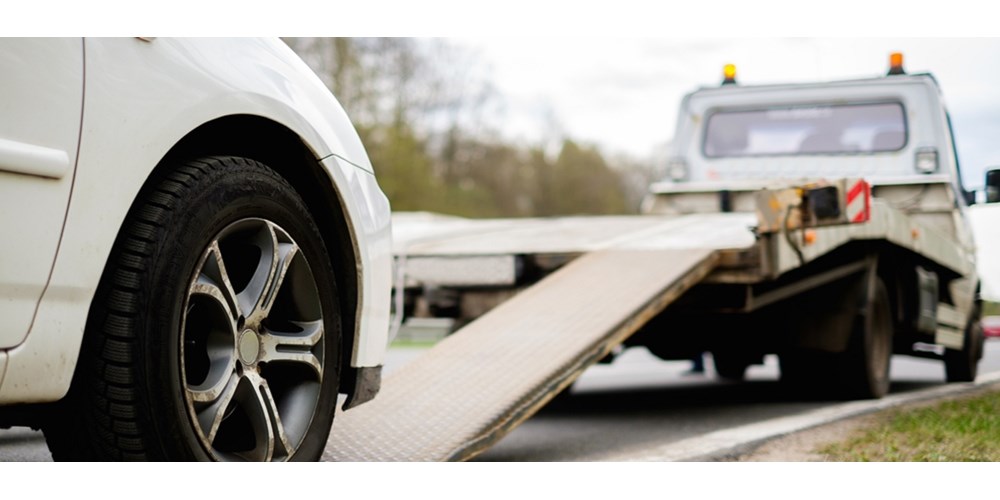 White car being towed away 