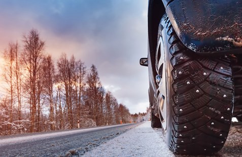 Cars driving on icy snowy road