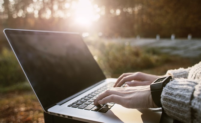 Working on a laptop outside