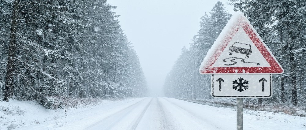 Icy roads sign on wintery road