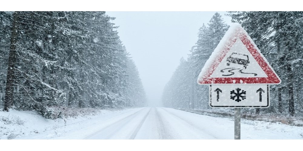Icy roads sign on wintery road