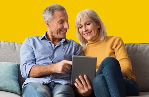 couple on sofa with tablet