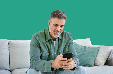 Man sits on sofa with phone