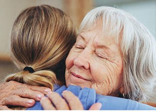 older woman hugs lady